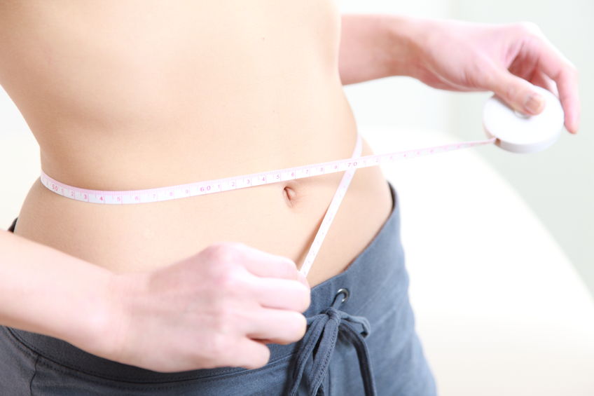 33020719 - woman measuring her waist